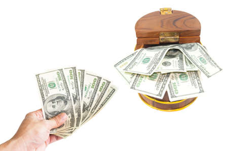 Saving concept : Money dollars in hand collect in wooden chestの写真素材