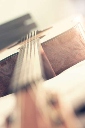 Guitar with depth of field lays on the bed