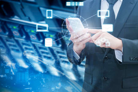 Double exposure of professional businessman connecting cloud internet smart phone with servers technology and connect world network in IT Business conceptの写真素材