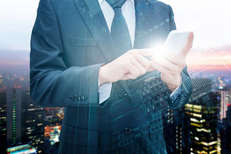 Double exposure of professional businessman using smart phone with servers technology in data center , city center of business and world map network connection in IT Business concept, world map from NASAの写真素材