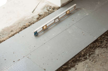 Floor tile installation and levelling for house building