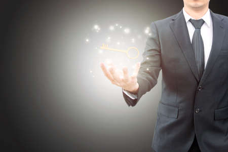 Businessman hand showing key to successの写真素材