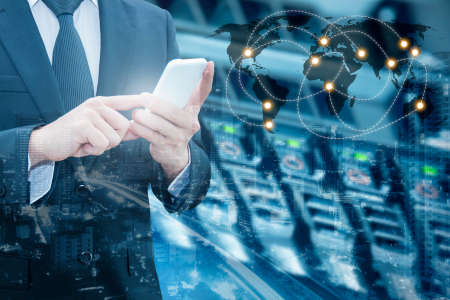 Double exposure of professional businessman connecting internet smart phone with servers technology and connect world network in IT Business concept,の写真素材