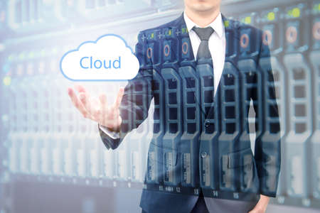 Double expoure of cloud computing concept on hand of a businessman with servers computing technology...