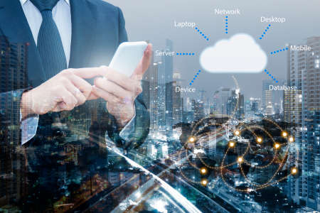 Double exposure of professional businessman connecting cloud internet smart phone with servers...