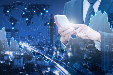 Double exposure of professional businessman connect internet smart phone and cityscape of business centre with international world financial graph, Business , finance , trading and banking conceptの写真素材