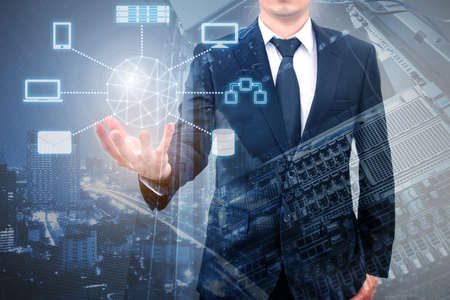 Double expoure of professional businessman connecting cloud technology on hand with cloud and sky in Technology, Communication and business conceptの写真素材