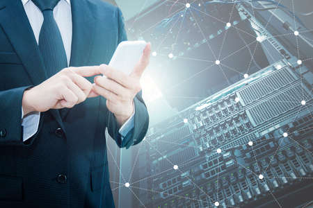 Double exposure of professional businessman using smart phone and network connection with server storage in datacenter background, Technology , communication & Business trading conceptの写真素材