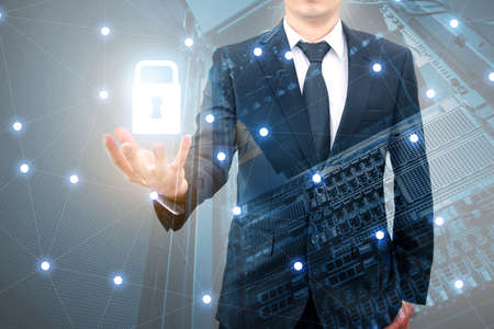Double exposure of professional businessman padlock security protection data safety and network connection with cityscpae in communication , technology and business conceptの写真素材