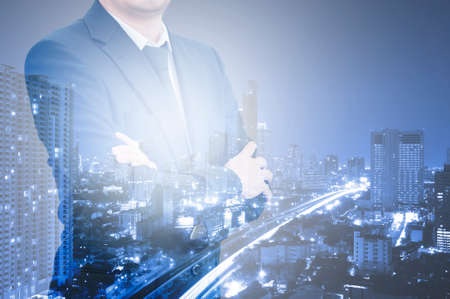 Double exposure photo a businessman and view of the cityDouble exposure professional businessman and city center of business, business conceptの写真素材