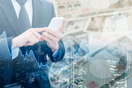 Double exposure of businessman connect internet network, Financial graph and cityscape with Japanese JPY Yen bank note pile background, Trading , Business and finance conceptの写真素材