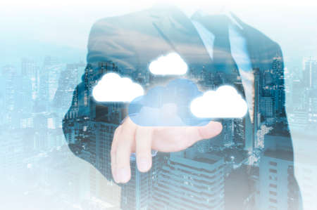Professional businessman touching blue cloud to connecting in cloud technology conceptの写真素材