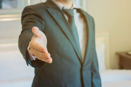 Professional businessman open hand ready for handshake and deal agreementの写真素材