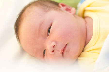 Closeup little newborn baby boy looking a cameraの写真素材