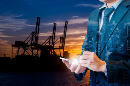 Double exposure of businessman touching with smart phone connected internet and network connection to transportの写真素材