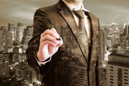 Double exposure of professional businessman touching screen with stylus penの写真素材