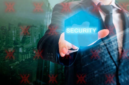 Double exposure of professional businessman touching security hexagonal polygon button on a digital interfaceの写真素材