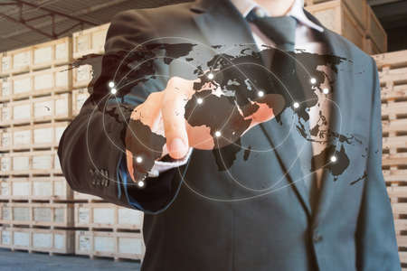 Double exposure of businessman touch screen on map to transport products at logistics port background, transportation trading business concept, world map element of this image furnished by NASAの写真素材