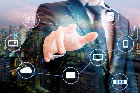 Double exposure of professional businessman touch on screen connected devices with world digital...