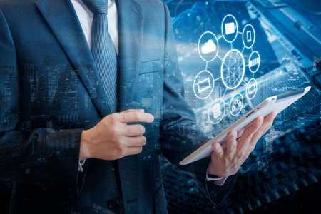 Double exposure of professional businessman connecting network and devices on hand in Cloud...