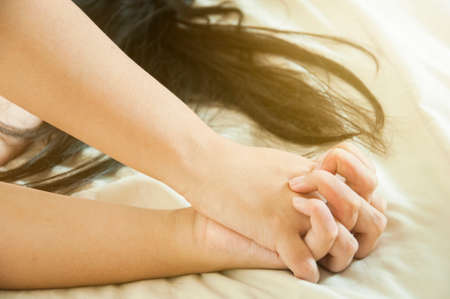 Close up hands of a couple make love hot sex on a bed