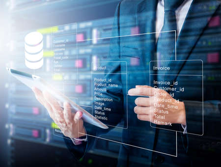 Double exposure of professional businessman connecting database with tablet devices on hand in Cloud...