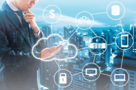 Double exposure of professional businessman connected Cloud technology with internet and wireless...