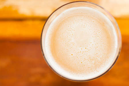 Top view of beer in cold glass on wood table backgroundの写真素材