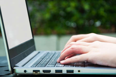 Businessman or businesswoman hand working on empty blank screen laptopの写真素材