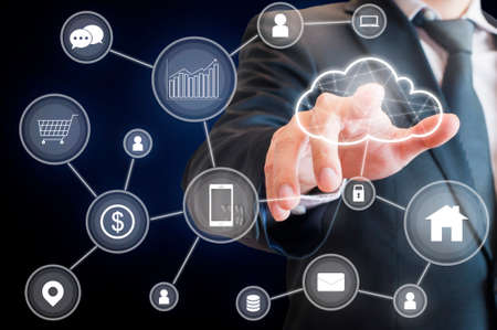 Professional businessman connecting cloud technology network and devices on hand in internet of things , technology , communication and business conceptの写真素材