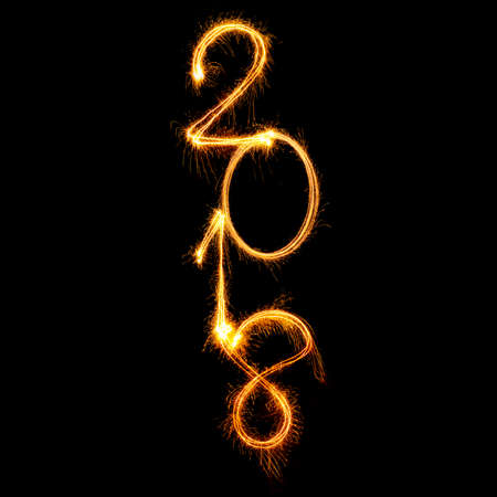 2018 vertical text align written with Sparkle fireworks isolated on black backgroundの写真素材