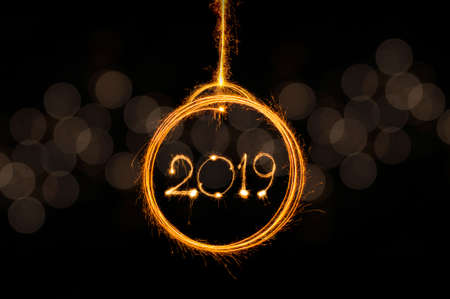 Happy new year 2019 text written with Sparkle fireworks isolated on black background