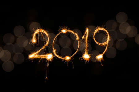 Happy new year 2019 text written with Sparkle fireworks isolated on black backgroundの写真素材