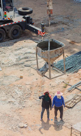 workes are mix Cement and put funnelの写真素材