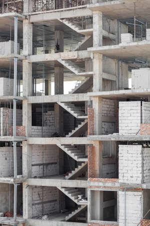 Up and down the stairs of the building that is being built の写真素材