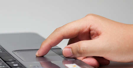 forefinger click to touchpad on the notebookの写真素材