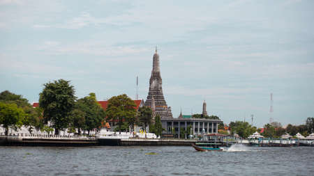 Temple waterfront and a boat in Thailand 