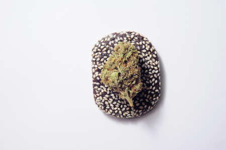 CBD cookies with cannabis and buds of marijuana on white table. Concept of cooking with cannabis herb. Treatment of medical marijuana for home usage in food.の写真素材