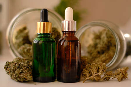 CBD oil on background with dry cannabis buds. Marihuana extract.の写真素材