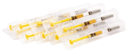 Hypodermic syringes in packets isolated on white.の写真素材