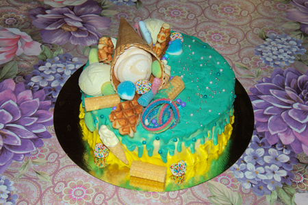beautiful birthday cake in icing with fillings of fruit, marshmallows, waffles, and fruitの写真素材