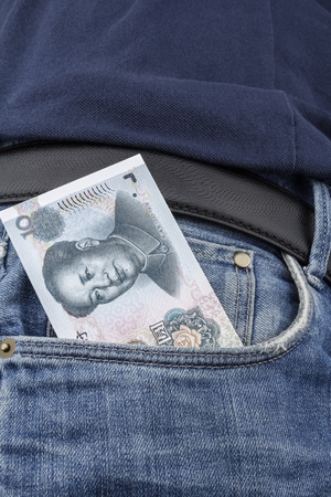 Chinese money (RMB) in the front pocket of a pair of blue jeans. (10 RMB note)の写真素材