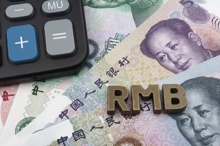 Chinese Yuan (CNY/RMB) banknotes with the letters RMB on top, and a calculator in the left top corner.の写真素材