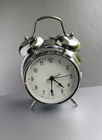 alarm clock on a gray background.の写真素材
