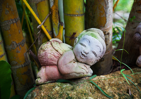 stone figurine on a bamboo backgroundの写真素材