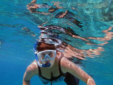 Girl snorkeling underwaterの写真素材