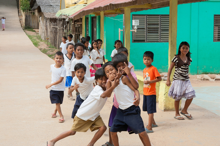 POPOTOTAN ISLAND, BUSUANGA, PHILIPPINES - JANUARY 20,2012 - Children playing on a school break in the Philippine villageのeditorial素材