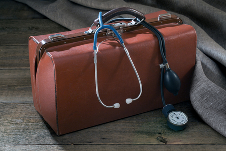 medical bag and pressure meter on the wooden tableの写真素材