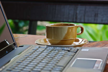 a cup of coffee and notebookの写真素材