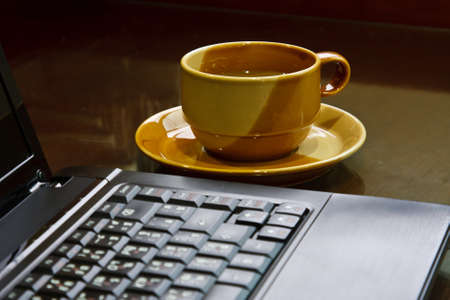 a cup of coffee with laptopの写真素材